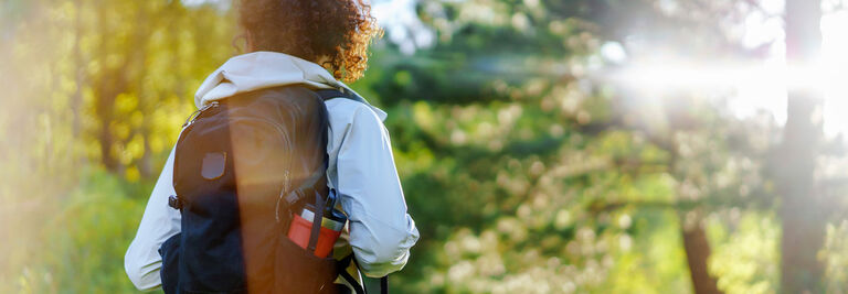 A woman walking through the woods